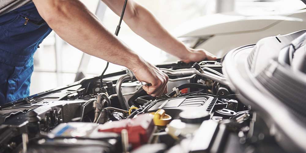Automotive technician servicing a vehicle